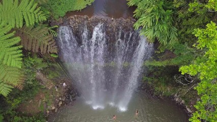 Aerial Descent: People Bathing Under Majestic Waterfall Among Lush Green, Atherton, Australia