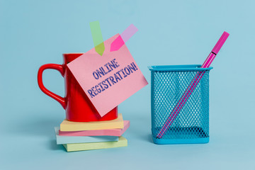 Handwriting text writing Online Registration. Conceptual photo Process to Subscribe to Join an event club via Internet Cup note arrow banners stacked pads metal pen holder pastel background