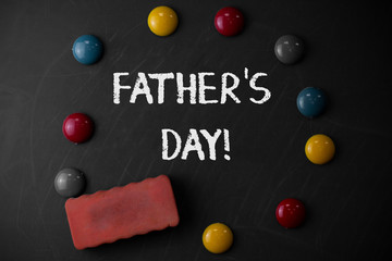 Word writing text Father S Day. Business photo showcasing day of year where fathers are particularly honoured by children Round Flat shape stones with one eraser stick to old chalk black board