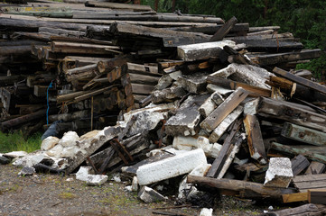 Pile of dirty styrofoam and weathered baulk timber