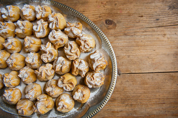 Homemade biscuit with violet hyacinth, white flower and yellow taraxacum on the wooden table