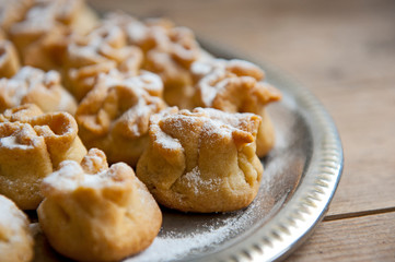Homemade biscuit with violet hyacinth, white flower and yellow taraxacum on the wooden table