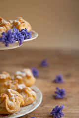 Homemade biscuit with violet hyacinth, white flower and yellow taraxacum on the wooden table