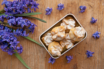 Homemade biscuit with violet hyacinth, white flower and yellow taraxacum on the wooden table