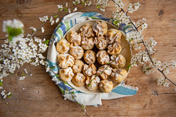 Homemade biscuit with violet hyacinth, white flower and yellow taraxacum on the wooden table