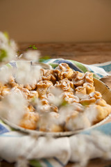 Homemade biscuit with violet hyacinth, white flower and yellow taraxacum on the wooden table