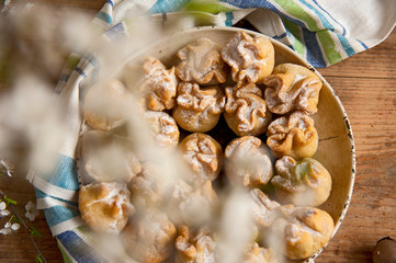 Homemade biscuit with violet hyacinth, white flower and yellow taraxacum on the wooden table