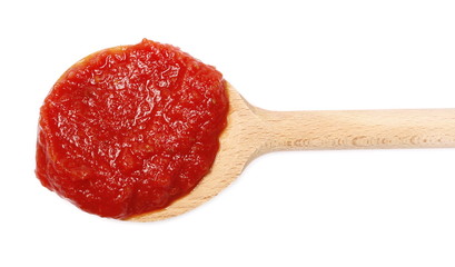 Tomato paste in wooden spoon, organic pure texture, isolated on white background