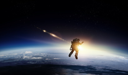 Astronaut in space on planet orbit.
