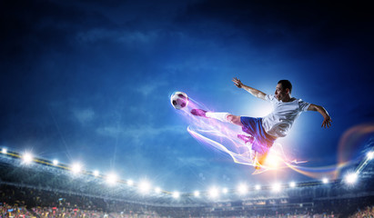 Obraz na płótnie Canvas Soccer player on stadium in action. Mixed media