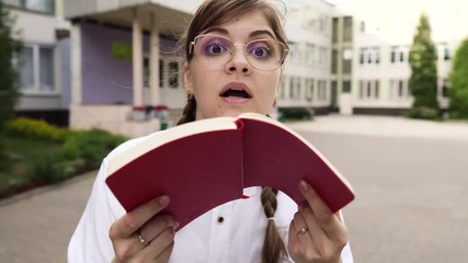 Portrait of a cute young woman in glasses .She is annoyed and expresses that she does not understand anything She is a strict teacher or a smart student or a qualified doctor, schoolgirl