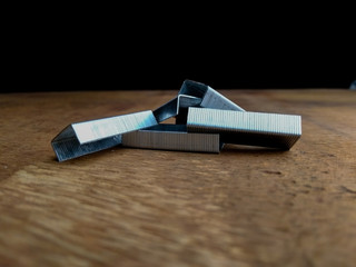 stapler pin on an table with black background