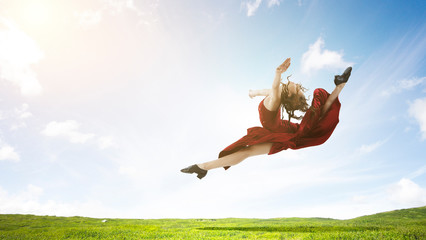 Young and beautiful female dancer in a red dress