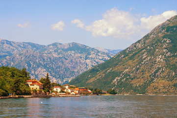 Fototapeta premium Summer vacations. Sunny landscape with sea, mountains and small seaside town. Montenegro, Adriatic Sea, Bay of Kotor, Prcanj