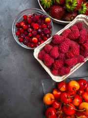 Berries on concrete Background. Summer or Spring Organic Berry. Strawberries, Raspberries, Cherry, Cranberries. Agriculture, Gardening, Harvest Concept