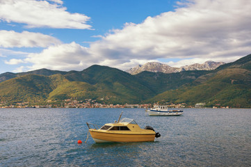 Fototapeta na wymiar Beautiful autumn Mediterranean landscape - mountains, sea and fishing boats on the water. Montenegro, Adriatic Sea, Bay of Kotor