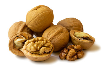 Isolated whole walnuts and walnut kernel halves without shell on a white background, close up. Seeds of the common walnut tree Juglans regia. Isolated macro food photo close up on a white background.