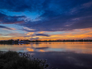Obraz na płótnie Canvas Lake view morning scenic above lotus lake with cloudy sky background, sunrise at Krajub Reservoir, Ban Pong, Ratchaburi, Thailand.