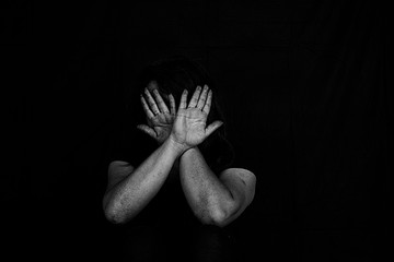 Victim with hands, victim of emotional stress and pain, abducted, abused, hostage, scared, restricted, trapped, may suffer, Stop violence and trafficking in women.