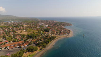Fototapeta na wymiar Aerial view coastal port city Gilimanuk place where ferry port for departure from Bali to the island of Java is located. Coastal city on the coast.