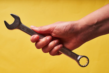 Girl holding a wrench in her hand