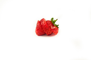 Fresh strawberries in a bowl on wooden table with low key scene.