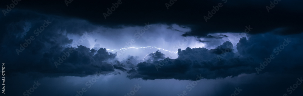 Wall mural panoramic view of lightning between the clouds