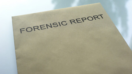 Forensic report, folder with important documents lying on table, investigation