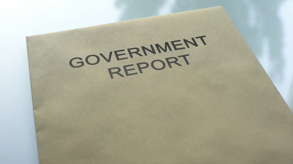 Government report, folder with important documents lying on table, close up