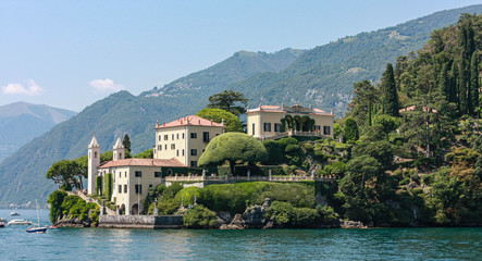 Fototapeta na wymiar boats, lake Maggiore, mountains silhouettes, summer, villa with towers, water