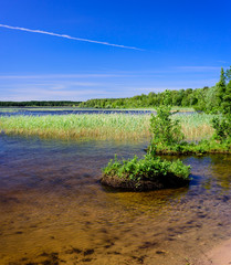 The picturesque shore of the lake, a beautiful summer landscape. Kavgolovskie lake is a popular vacation spot near the village of Toksovo, Leningrad region, Russia