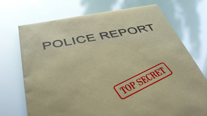 Police report top secret, seal stamped on folder with important documents