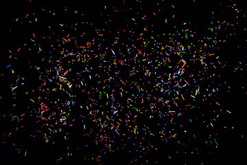 colorful patisserie sprinkled over black background