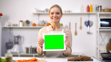 Cheerful woman holding tablet with green screen, cooking blogs and apps template