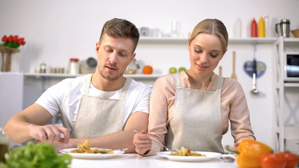 Nice couple eating pasta, Italian cuisine, family traditions, cooking courses