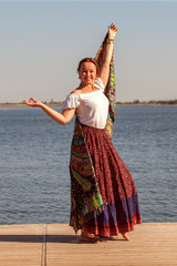 Young woman doing yoga in morning park