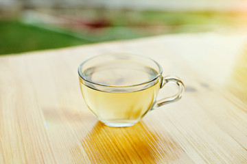 Green tea in a cup on wooden table