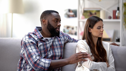 Loving black boyfriend calming girlfriend and trying to reconcile after quarrel
