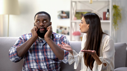 Annoyed black man ignoring conversation with girlfriend, misunderstanding