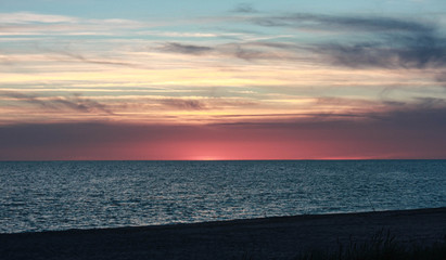 Fototapeta na wymiar clouds, pink horizon, sea, seaside evening view after sunset