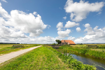 Fototapeta na wymiar charming farmhouse and blue sky in summer