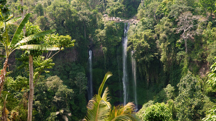 waterfall in green rainforest. triple tropical waterfall Sekumpul in mountain jungle. Bali,Indonesia. Travel concept. Aerial footage.