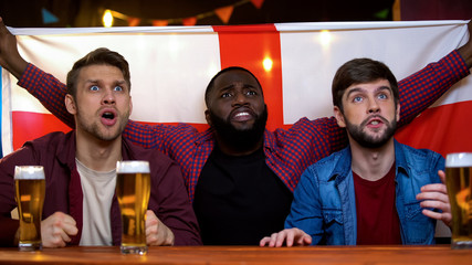 English football team losing game, multiracial male football fans disappointed