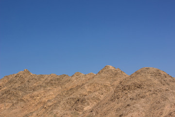 Fototapeta na wymiar desert mountain ridge nature scenery landscape background horizon line board with empty blue sky, copy space for text