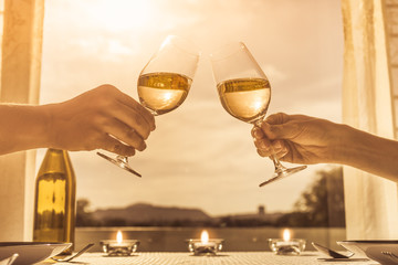 Peoples hands holding glass of wine celebrating together.   
