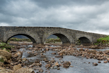 Fototapeta na wymiar The old stone bridge at Slgachan on the Isle of Skye, north west Scotland, UK.