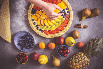 Female Hands Prepare Fruit Pie with Colorful Fruits and Fresh Dough