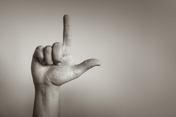 Hand making L shape. Looser symbol concept