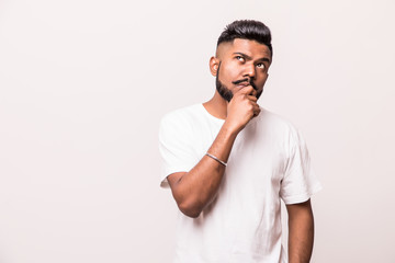 Impressed man with a confident look , putting his fingers under his chin, isolated on a white...