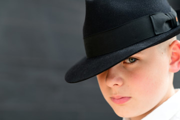 Portrait of handsome  young man wearing tilted classic  black hat